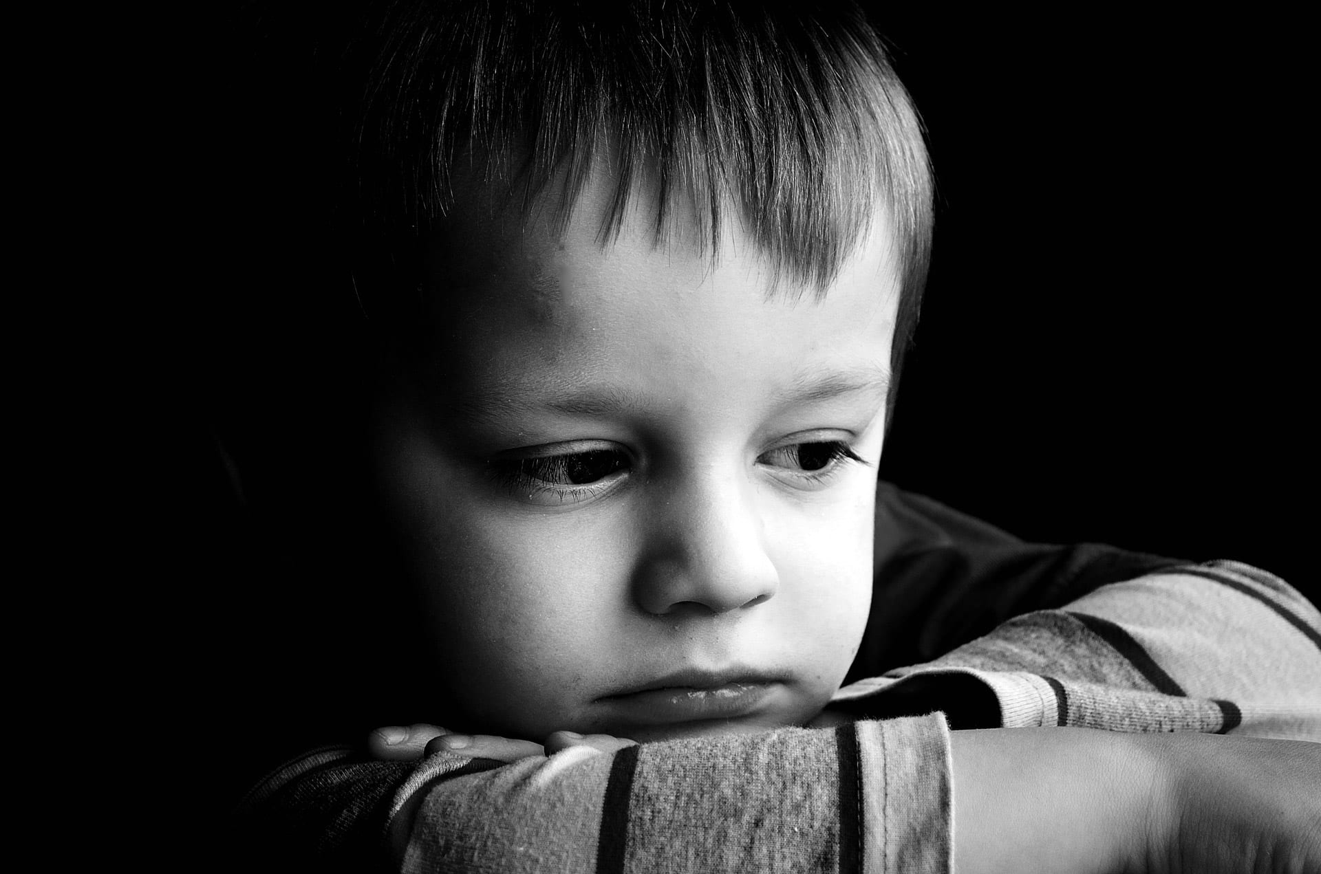Sad little boy in black and white