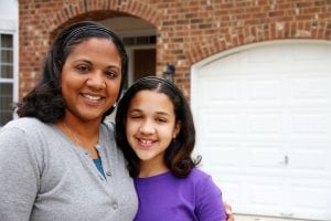 A mixed race mother and daughter at their home