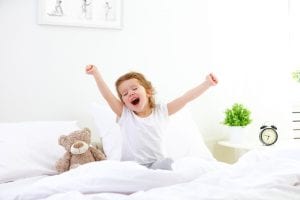 foster care child waking up in bed